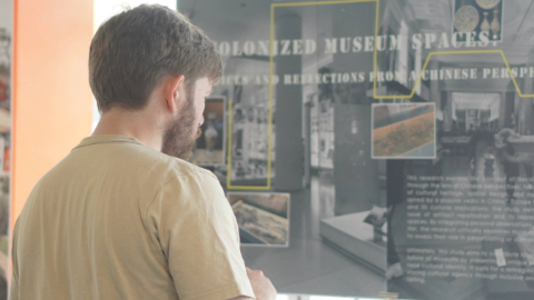 Student looking at a poster