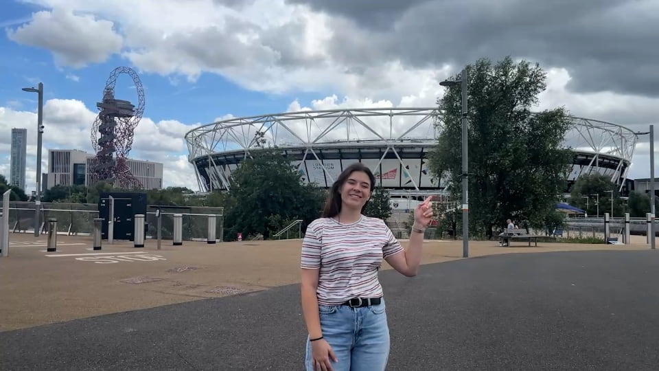 Image of the student stood in front of the West Ham stadium