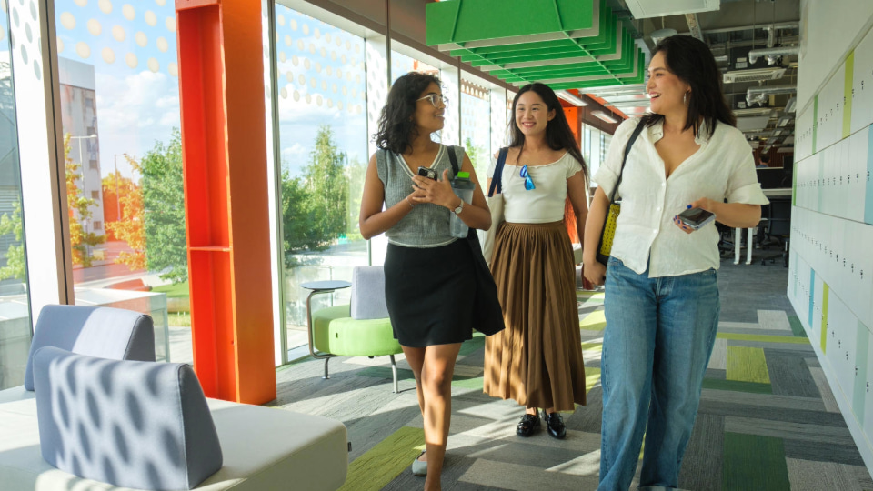 Three students walking on campus