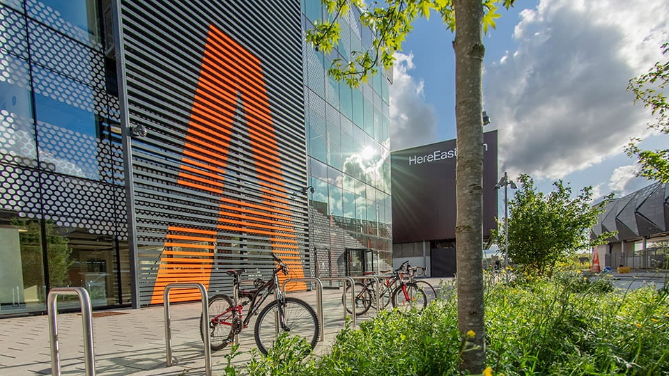 Outside view of the Loughborough University London building with some trees and bicycles