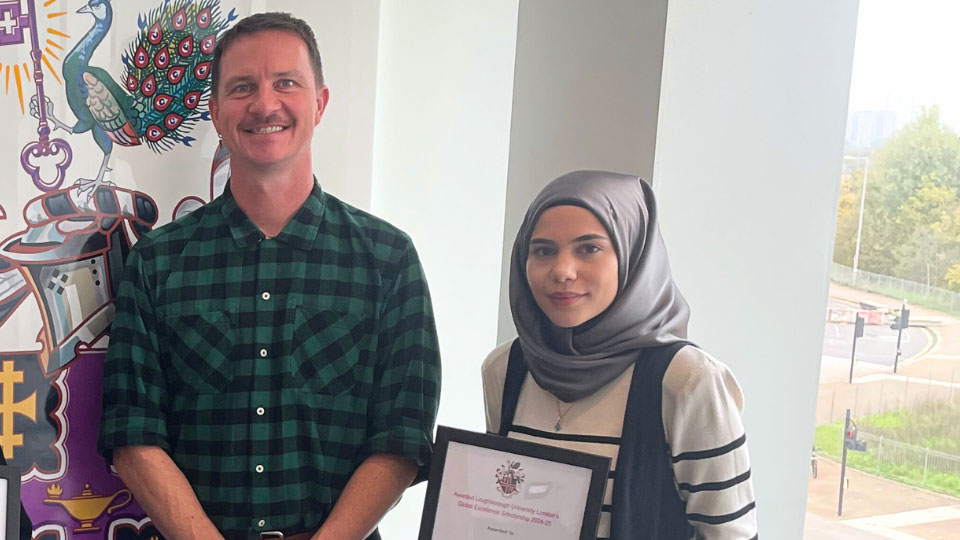 Imannur holding a certificate