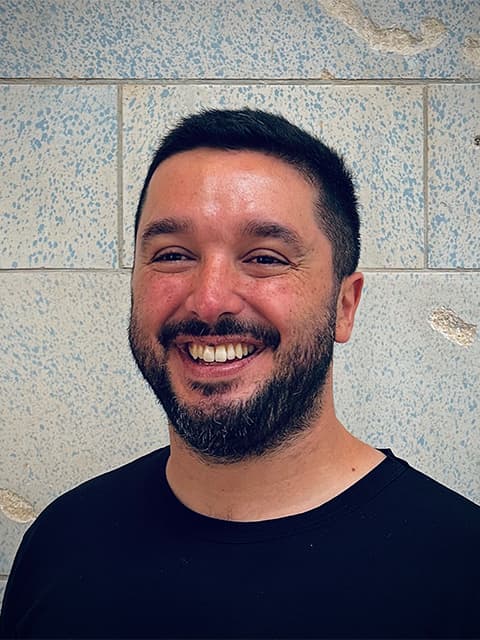 Photo of Andres Urena in front of a brick wall
