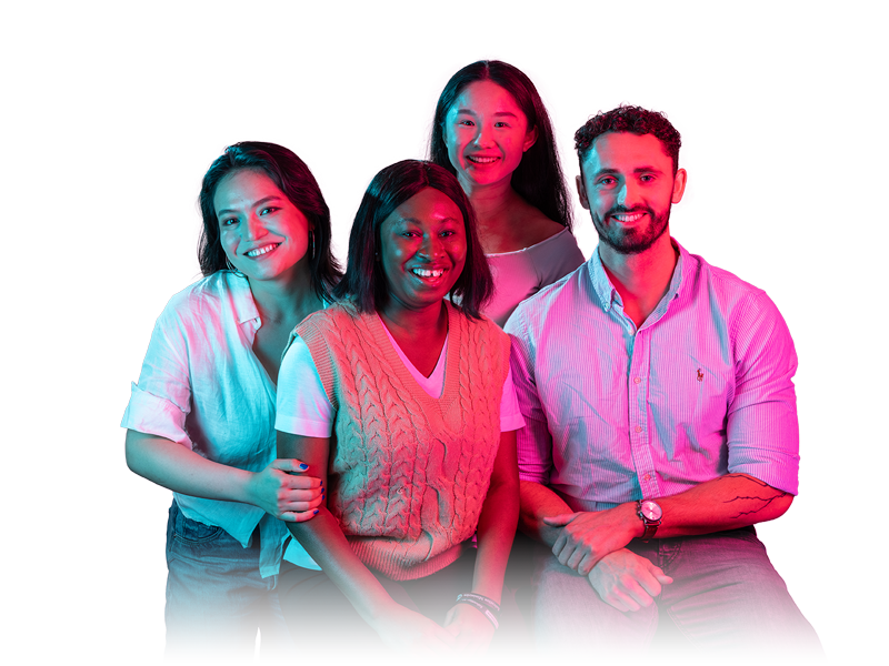 Four students in a studio setting with colourful gel lighting
