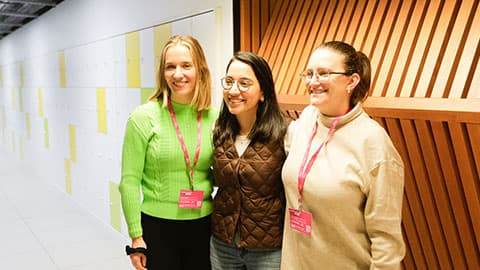 three people pose for a photo