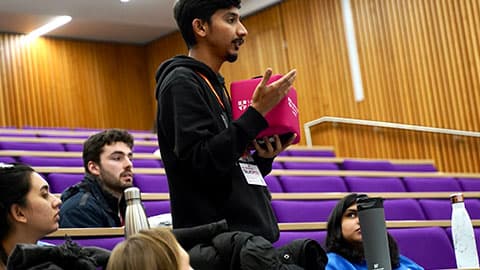 a audience member stands to ask a question