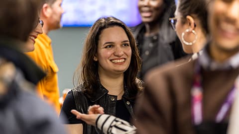 Woman smiling whilst having a conversation