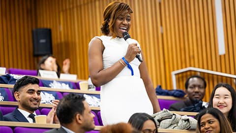 Student standing up and talking into microphone at the Chevening Conference 2026