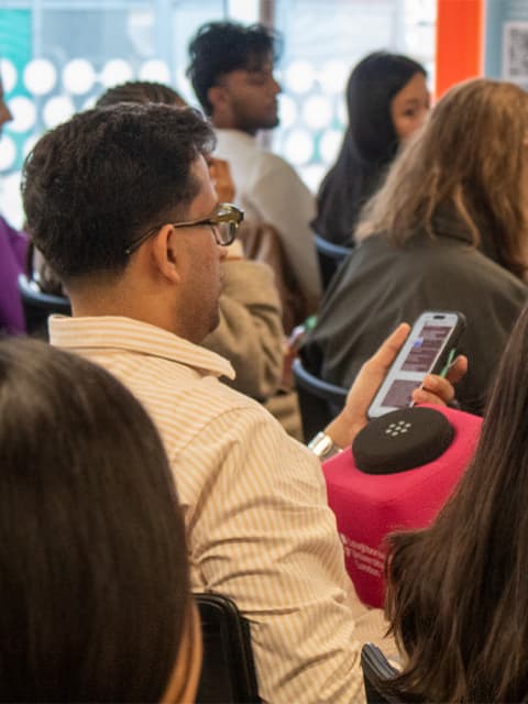 A male student reading a question from his phone