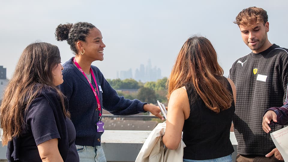 Image of students smiling and talking amongst each other