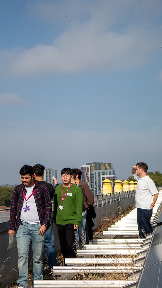 Image of students standing on Here East rooftop