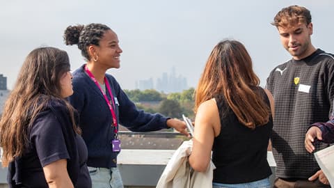 Image of students smiling and talking amongst each other